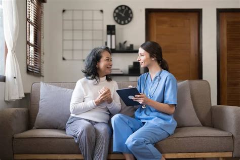 Asian Nurse Showing Health Checkup Report To Grandmather And Giving