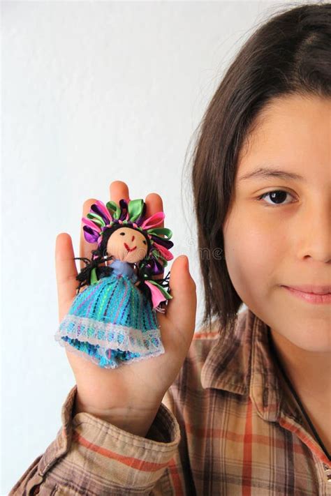 10 Year Old Hispanic Latina Girl Shows Her Favorite Toy And Dessert In The Form Of A Traditional