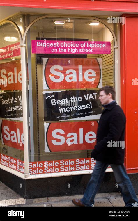 A Man Walks Past A Shop Window Advertising Its Sale A Poster