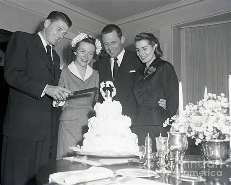 Ronald And Nancy Reagan Slicing Wedding by Bettmann