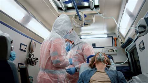 Doctors Holding Samples Of Coronavirus Test Patient Transferring To