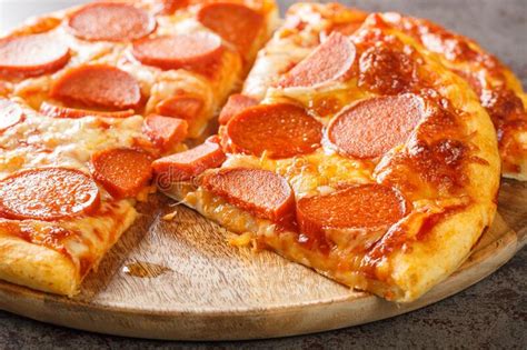 Delicious Sliced Pepperoni Pizza With Sausage And Cheese Close Up On A