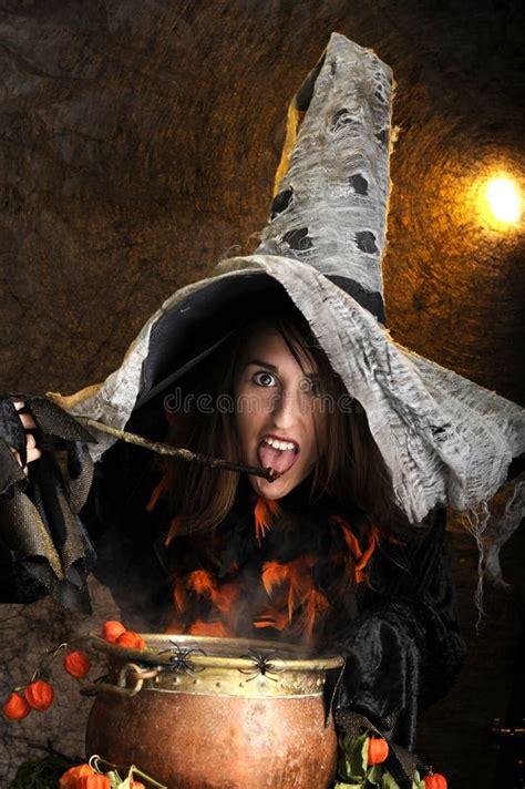 Halloween Witch Cooking A Potion In A Cauldron Stock Photo Image Of