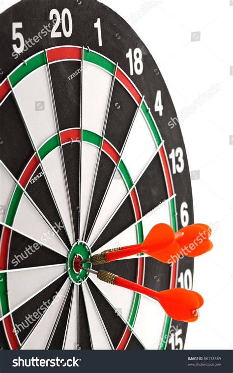 Darts Hitting The Bullseye On A Dartboard Stock Photo