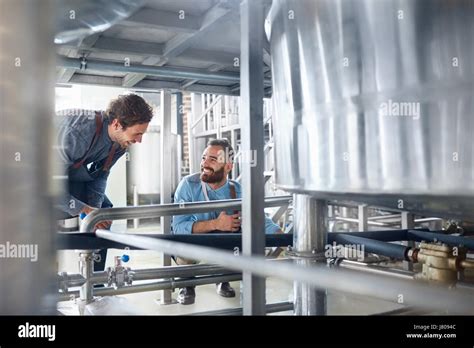 Male Brewers Talking Vat In Brewery Stock Photo Alamy