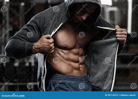 Muscular Man With Open Jacket Revealing Chest And Abs In Gym, Workout ...