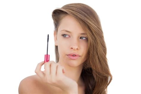 Premium Photo Serious Brunette Model Looking At A Mascara Tube