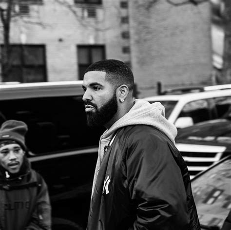 Black and White Photo of Drake Walking Down the Street