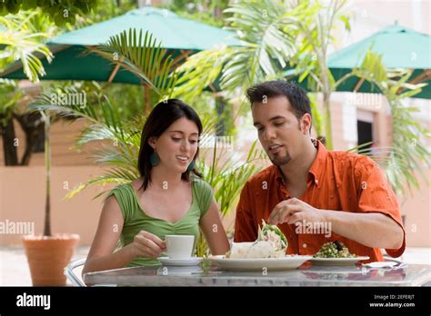 Teenage Girl And A Mid Adult Man Sitting In A Restaurant Stock Photo