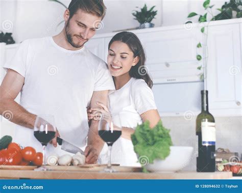 Beautiful Young Couple Preparing A Healthy Meal Together While Spending