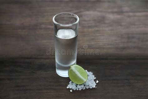 Mexican Tequila Shot With Lime Slice And Salt On Wooden Table Drink