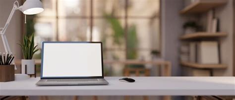 Premium Photo | A white table with a laptop computer and decor is ...