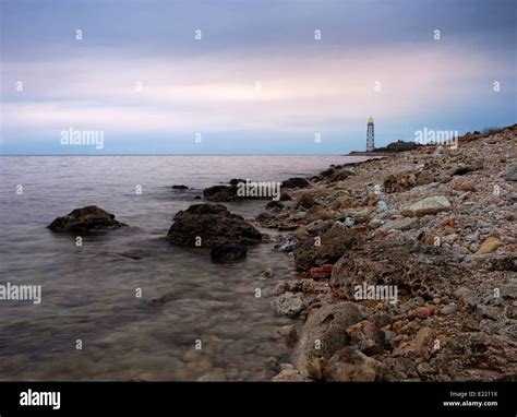 Lighthouse At Rocky Shore Stock Photo Alamy