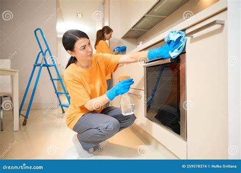 Young Pretty Ladies In Uniform Are Cleaning Stock Photo Image Of Hard