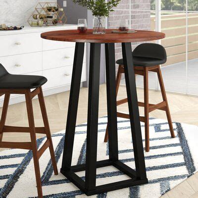 A Kitchen Table With Two Stools Next To It