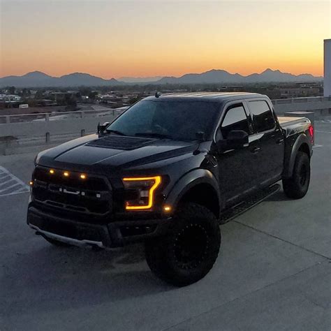 a black truck parked on top of a parking lot