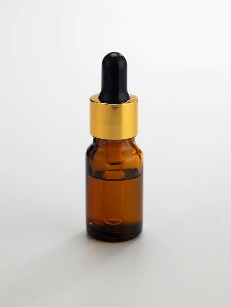 Premium Photo Close Up Of Essential Oil Bottle Against White Background