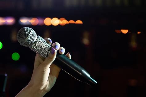 Premium Photo Closeup Of Woman Hand Holding Microphone On Stage Copy