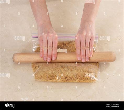 Crushing Digestive Biscuits To Crumbs With A Rolling Pin For