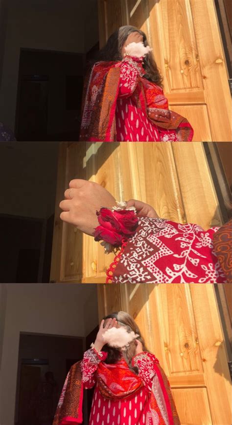 A Woman In Red And White Dress With Her Hands On Her Face Standing