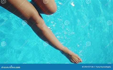 Closeup Legs Of Tanned Woman Playing And Splashing In Pure Water At