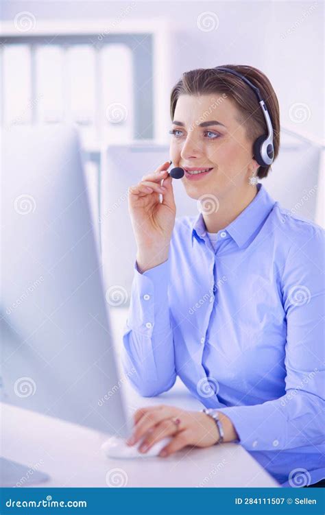 Serious Pretty Young Woman Working As Support Phone Operator With