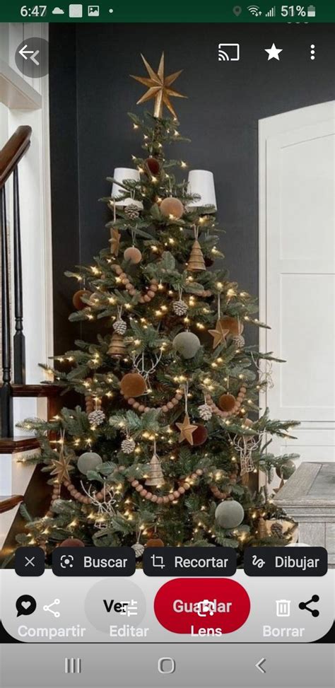 A Christmas Tree With Lights And Ornaments In A Basket On The Floor