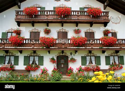 traditional Bavarian farmhouse richly decorated with flowers near Bad Toelz Bavaria Germany ...