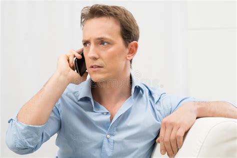 Serious Man Talking On Phone Stock Photo - Image of interior, doubt ...