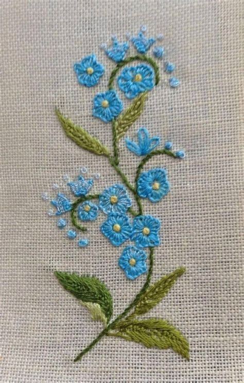 Blue Flowers Are Embroidered Onto The Side Of A Piece Of Cloth With