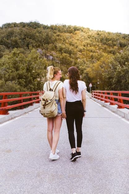 Premium Photo Rear View Of Women Walking On Road