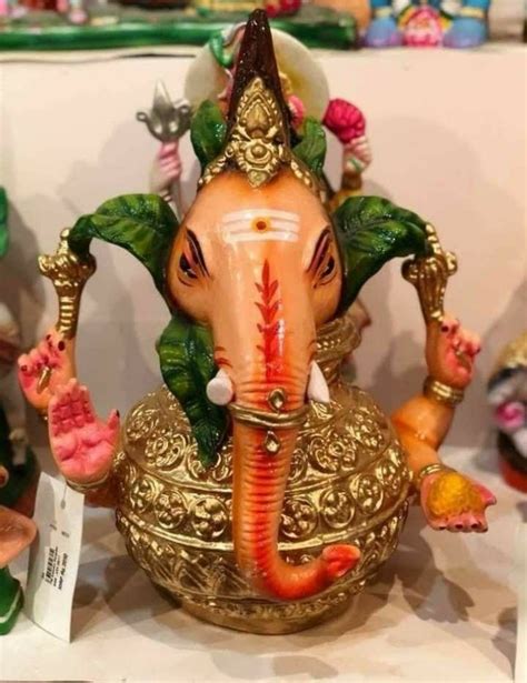 An Elephant Statue Sitting On Top Of A Table Next To Other Figurines