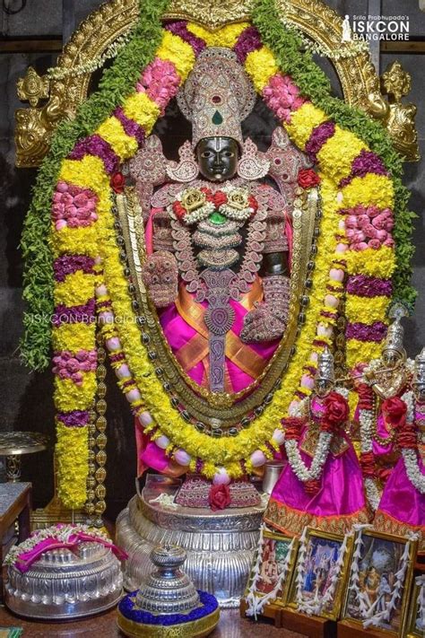 The Idol Is Surrounded By Flowers And Other Decorations