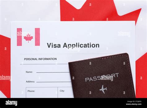 Immigration To Canada Visa Application Form And Passport On Flag Top