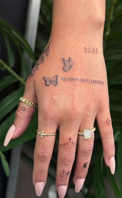 A Woman S Hand With Tattoos On It