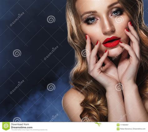 Beautiful Model Girl With Long Curly Hair And Red Lips Red Mani Stock