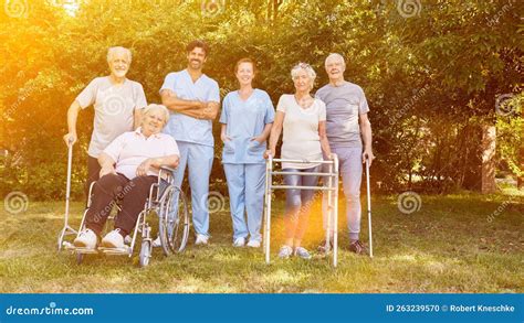 Group Of Seniors With People In Wheelchairs And With Walkers Stock