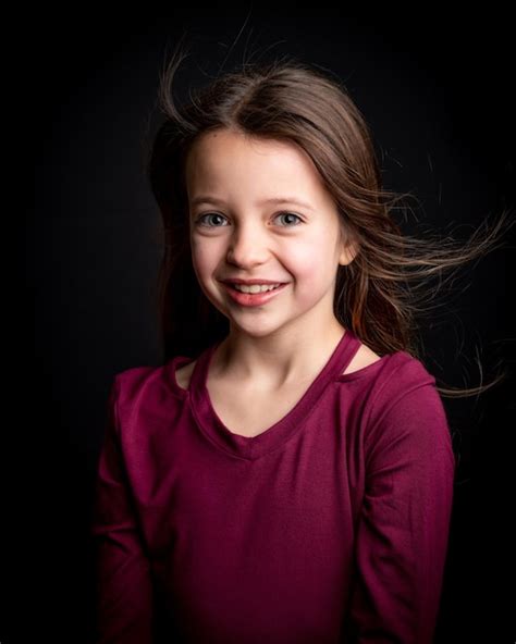 Premium Photo Portrait Of Cute Girl Standing Against Black Background