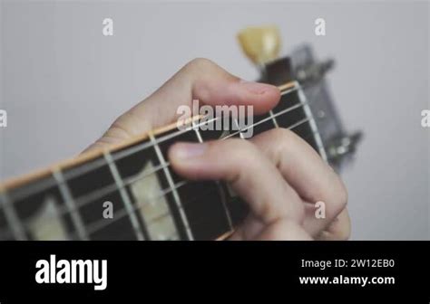 Hands Playing Chords On Guitar Fretboard And Headstock Guitarist Playing Songs On Guitar Stock