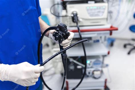 Premium Photo Doctor Proctologist Holding Endoscope During