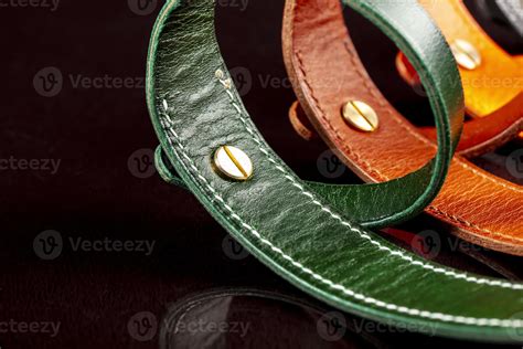 A Group Of Multi Colored Leather Belts On A Black Background 20496352