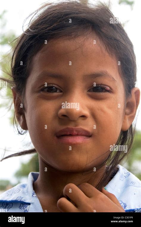 A Young Girl Living In Poverty Is Enjoying Her Day At Her Home In