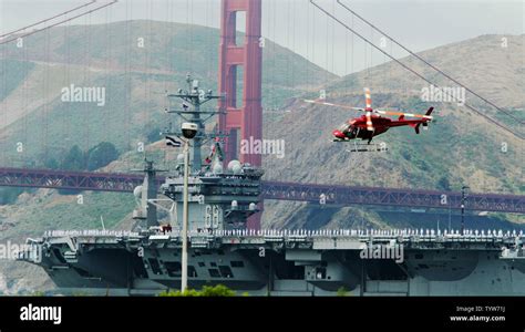 The Crew Of The Uss Nimitz Man The Rails As The Aircraft Carrier Sails