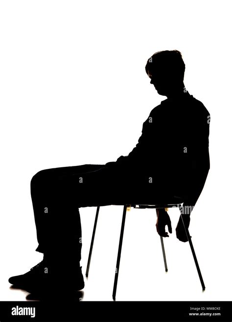 silhouette of a man sitting on a chair Stock Photo - Alamy