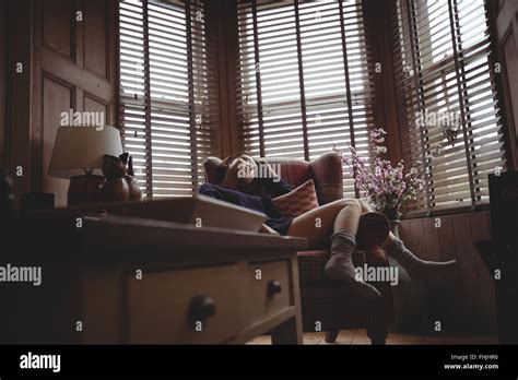 Brunette Relaxing On The Sofa Stock Photo Alamy