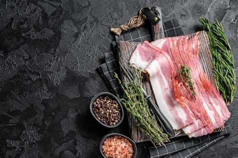 Premium Photo Raw Smoked Bacon Slices With Rosemary And Thyme On