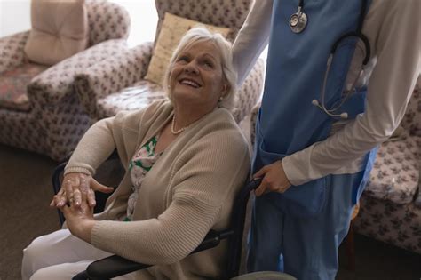 Premium Photo Female Doctor Interacting With Disabled Senior Woman In