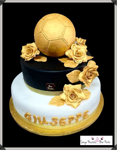 A Three Tiered Cake Decorated With Gold Roses And A Soccer Ball On The Top