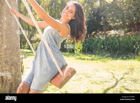 Pretty Brunette Swinging In Park Stock Photo Alamy