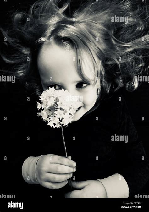 Girl smiling with flowers Stock Photo - Alamy